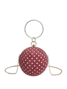 Pink velvet spherical evening clutch with white polka dots and diamond-encrusted ring handle