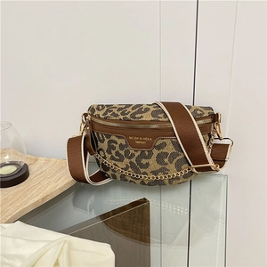 Detail of leopard print crossbody bag with wide strap and gold chain decoration