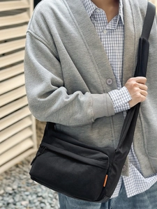 Black nylon crossbody bag with adjustable strap and large capacity for daily commuting