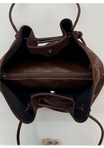 Detailed interior of the dark brown suede tote bag with three compartments and magnetic snap