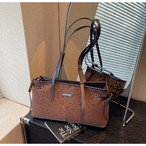 Close-up of vintage brown leopard print shoulder bag with adjustable straps and logo