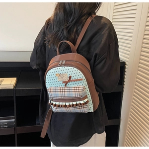Close-up of a sweet bow backpack with mixed star canvas and brown leather panels