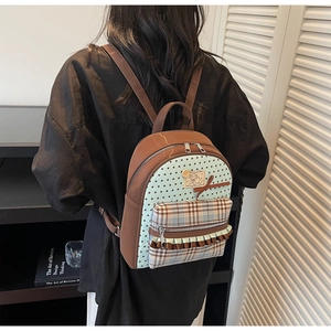 Detail view of stylish bow backpack with plaid pocket and cute star pattern for women