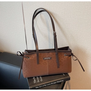 Detail of vintage leopard print accent and Sunny Day leather tag on brown shoulder bag