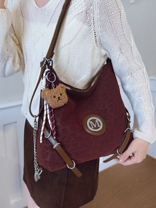 Wine red leopard print tote bag with adjustable brown leather strap and bear charm
