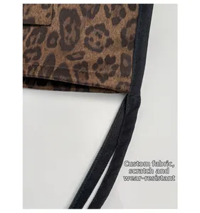 Detailed macro view of scratch-resistant leopard print suede fabric with black trim