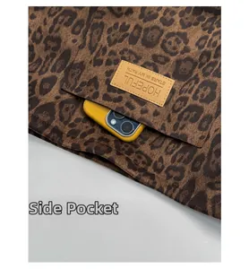 Detail of leopard print tote side pocket with HOPEFUL leather patch and phone storage