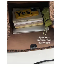 Detailed interior view of leopard print suede tote bag with laptop and daily essentials