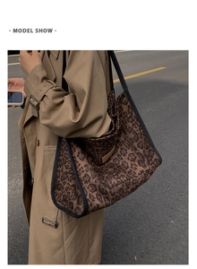Detail of vintage leopard print tote bag featuring wide shoulder straps and side trim