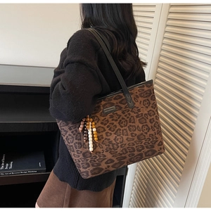 Fashionable large leopard print tote bag with beaded tassel detail on a shoulder strap