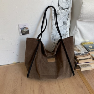 Close-up of deep brown leopard print tote bag with HOPEFUL patch and suede texture