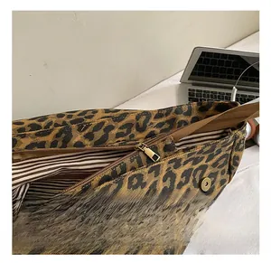 Detail view of leopard print backpack showing the durable metal zipper and striped lining
