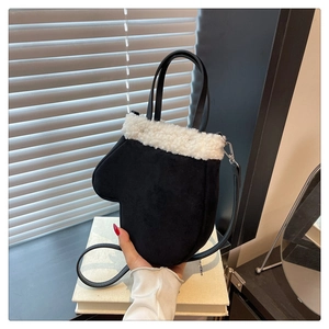 Close-up of black mitten-shaped crossbody bag with white faux shearling fur trim