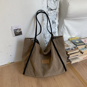 Close-up of retro brown canvas tote bag with Hopeful leather tag and checkered lining