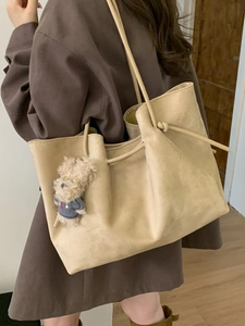 Retro oversized beige suede tote bag with a cute bear charm and drawstring detail