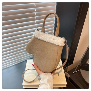 Detail of khaki faux suede glove-shaped bag with white plush trim and silver hardware