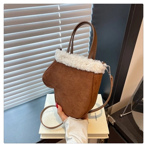 Detail showing the brown suede texture and white faux fur trim on this glove-shaped bag