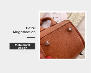 Detail magnification of metal rivets on brown lychee grain leather bucket bag base