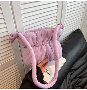 Detail of light purple quilted puffer cloud bag with thick padded knotted handle