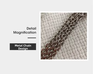 Detail magnification of high-quality silver metal chain hardware on beige knit fabric