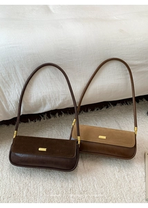 Detailed view of the matte suede and smooth leather splicing on a retro square shoulder bag