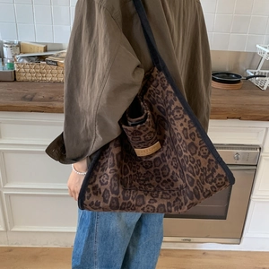 Detail of leopard print tote bag with Hopeful leather label and black shoulder strap
