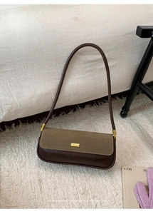 Detail of vintage patchwork baguette bag with brown leather and olive suede texture