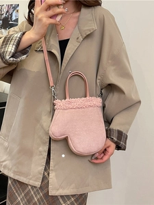 Pink mitten-shaped plush bag with faux shearling trim and adjustable shoulder strap