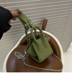 Detail of olive green lychee leather mini bucket bag with silver chain strap