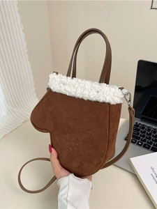 Brown glove-shaped crossbody bag with white faux fur trim and adjustable strap