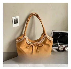 Detail view of yellow tote bag with fuzzy white faux fur trim and bowknot drawstring
