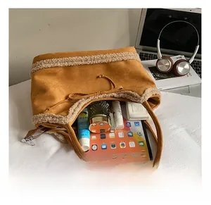 Interior view of suede tote bag showing large capacity with tablet and beauty items