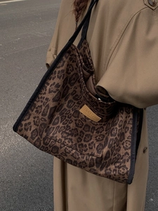 Large leopard print canvas tote bag with black strap and hopeful leather patch