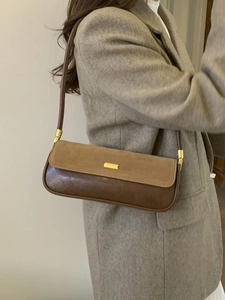 Classic brown two-tone baguette bag with suede texture and gold metal buckle detail