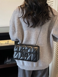 Classic black quilted crossbody bag with metal chain strap and turn-lock closure