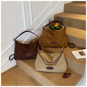 Three suede leather tote bags in brown and beige colors on steps for size comparison