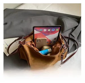 Spacious interior of brown suede tote bag holding a tablet and daily essentials
