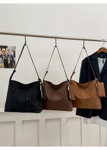 Detailed trio of leopard print matte tote bags in black, dark brown, and caramel shades