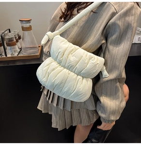 Macro detail of soft quilted off-white cloud bag with padded knotted shoulder strap