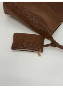 Detail of dark brown leopard print tote bag with a matching small zipper pouch
