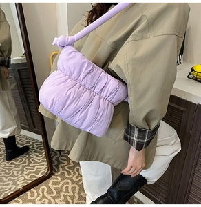 Detail of light purple puffy cloud bag showing quilted texture and knotted wide strap