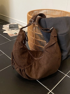 Deep brown suede hobo bag with pleated drawstring design and adjustable strap