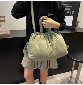 Detailed macro view of olive green quilted puffer tote bag with thick padded handle