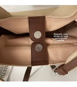 Detail view of canvas tote interior with magnetic snap closure and zipped security pocket