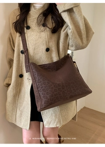 Minimalist dark brown leopard print bucket bag styled with a beige cashmere coat