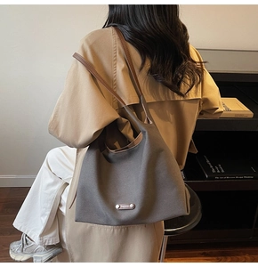 Detail showing high-density canvas tote with leather straps for daily commute use