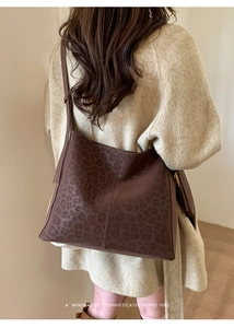 Detailed view of dark brown leopard print tote bag with adjustable long shoulder strap