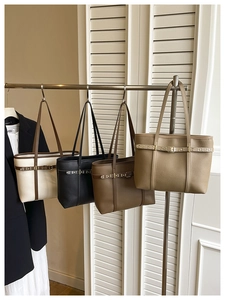 Detail view of lychee texture tote bags in four colors with gold rivet hardware