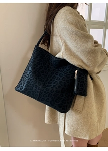Detail of minimalist retro leopard print tote bag with a matching small zipper pouch