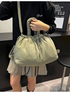 Olive green quilted puffer tote bag with drawstring closure and shoulder strap for women